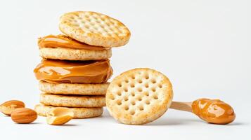 A stack of crackers with peanut butter and nuts photo