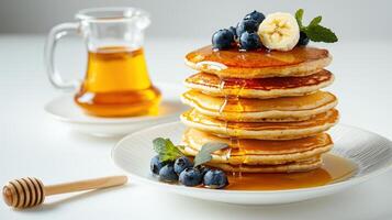 A stack of pancakes with blueberries and syrup photo