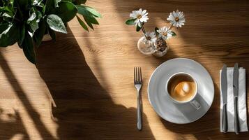 A cup of coffee and a knife and fork on a table photo