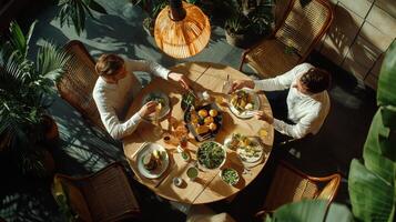 Two men sitting at a table eating food photo