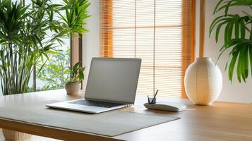 A laptop sitting on a wooden desk near a window photo