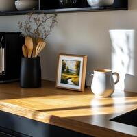 A kitchen counter with a picture on it and a vase photo