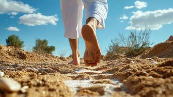 A person walking on the sand with their bare feet photo