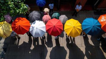 A group of people standing under umbrellas photo