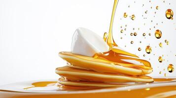 Pancakes with syrup being poured over them photo