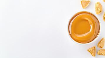 Caramel sauce in a bowl on a white background photo