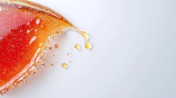 A piece of orange juice being poured into a glass photo
