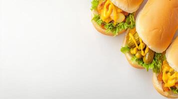 Four hot dogs with cheese and lettuce on a white background photo