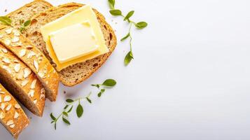 Bread with butter and herbs on white background photo