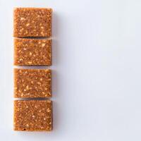 Four bars of chocolate covered in peanut butter photo