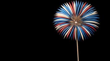A red, white and blue flower on a stick photo
