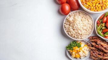 A variety of food is arranged in bowls on a white table photo