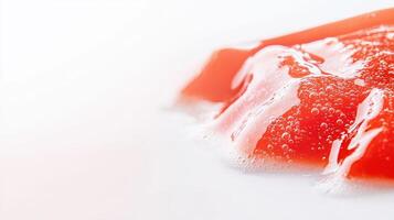 A piece of red jelly on a white surface photo