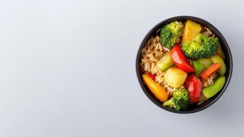 A bowl of vegetables and rice with a spoon photo