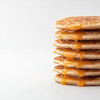 A stack of pancakes with caramel syrup on top photo