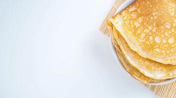 A stack of pancakes on a white plate photo