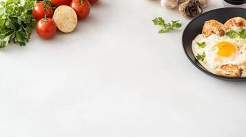 Fried eggs, tomatoes and mushrooms on a white table photo