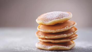 Stack of pancakes with powdered sugar on top photo