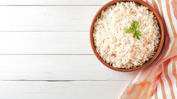 Rice in a bowl on a white wooden table top view photo