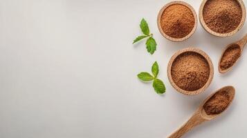 Cocoa powder in wooden bowls and spoons on white background photo