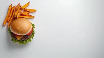 A hamburger and fries on a white background photo