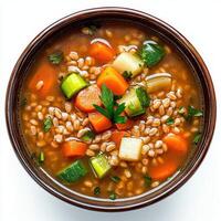 A bowl of vegetable soup with carrots, celery and parsley photo