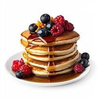 A stack of pancakes with berries and syrup photo