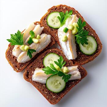 Three slices of bread with cucumbers and herbs photo