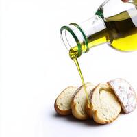 A person pouring olive oil onto bread photo