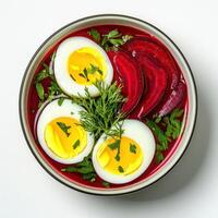 Beetroot soup with boiled eggs and herbs photo
