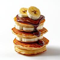 A stack of pancakes with chocolate and bananas photo