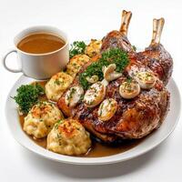 A plate of food with a roast duck, potatoes and gravy photo