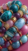 Colorful bracelet collection featuring gemstones on a vibrant surface with intricate details showcased in bright light photo