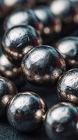 Close-up view of metallic spheres arranged artistically on a dark surface showcasing their reflective properties photo