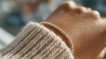 Elegant wrist adorned with a sparkling bracelet against a soft sweater texture in natural light photo