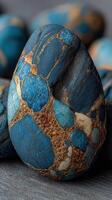 Artistic close-up of a uniquely patterned blue and gold stone displayed on a smooth surface photo