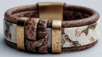 Unique brown and white leather bracelet with metallic accents on a neutral background photo