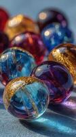 Colorful glass marbles arranged on a smooth surface display an array of vibrant hues and intricate designs under soft lighting photo