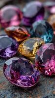 Colorful gemstones arranged on a textured surface showcasing their brilliant cut and reflections in natural light photo