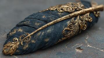 Ornate golden feather with intricate design resting on a textured stone surface photo