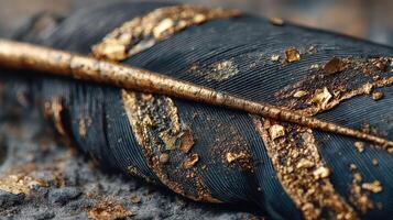 Golden dust covers a black feather resting on a textured surface in an artistic composition photo