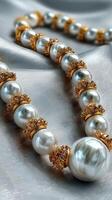 Elegant pearl necklace with intricate gold accents displayed on smooth satin fabric photo
