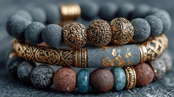 Beautiful handmade bracelets with intricate designs crafted from natural stones and metals displayed on a textured surface photo