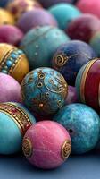 Colorful decorative beads with intricate designs arranged on a textured surface display unique craftsmanship and artistic detail photo