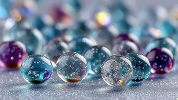 Colorful spherical gel beads scattered on a flat surface showcasing vibrant hues and bubbles during daylight photo