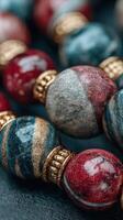 Beautifully crafted decorative beads in red, blue, and gold displayed in an artistic arrangement photo