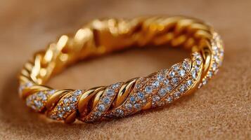 Intricate gold bracelet adorned with sparkling gems showcased on a textured backdrop photo