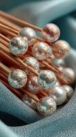 Decorative pearl picks arranged neatly on blue fabric with golden accents photo