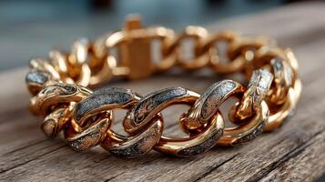 Intricate gold and silver chain bracelet crafted with detailed patterns on a wooden surface photo