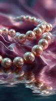 Elegant pink pearls draped over silky fabric reflecting in water photo